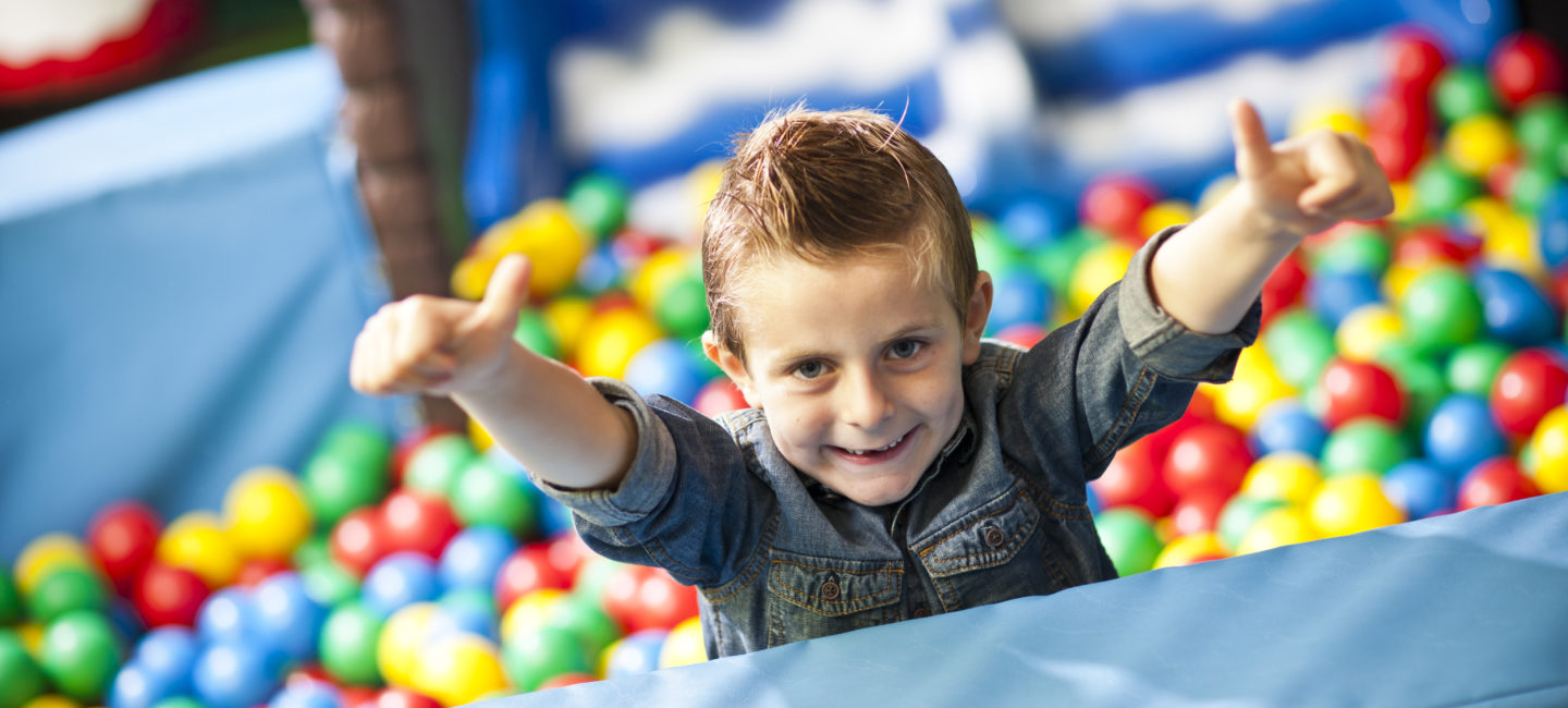 Young boy in Wacky Warehouse Ball Pit