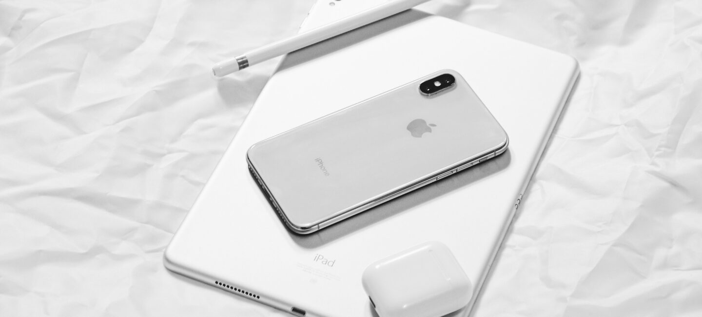 An iPhone, iPad and Airpods