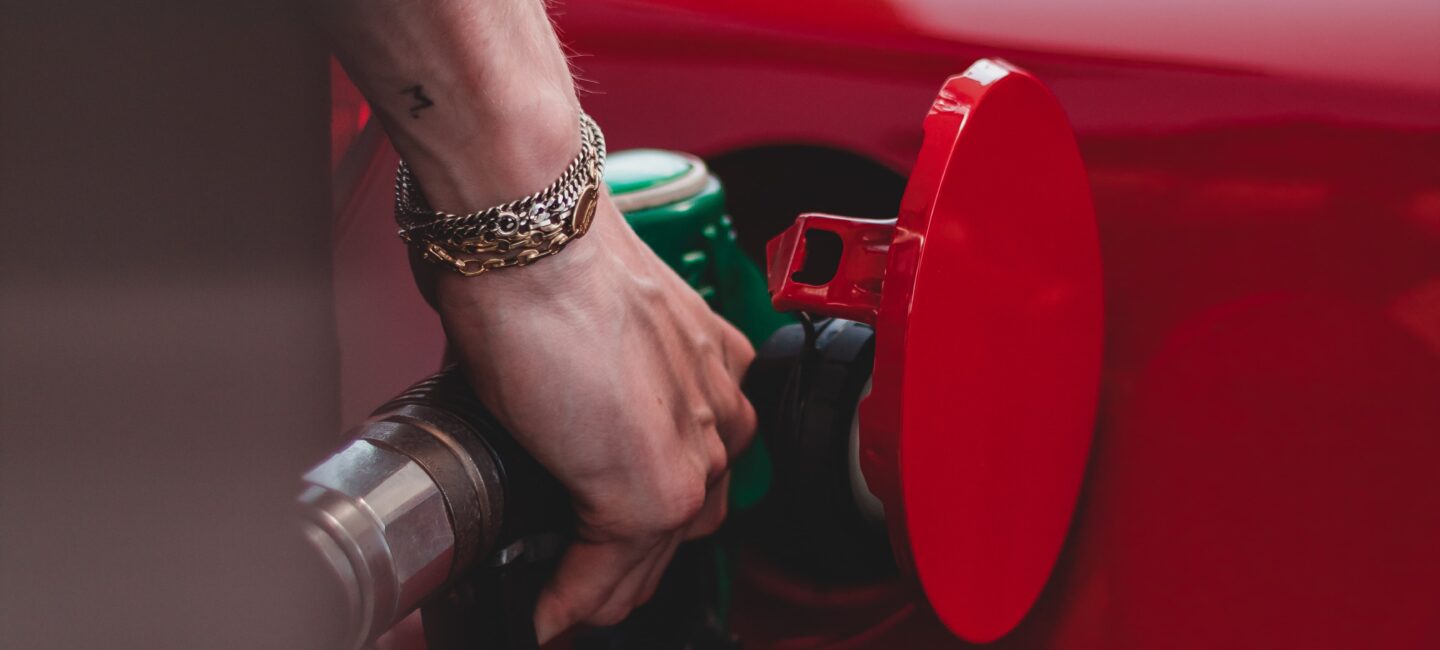 Close up of hand filling up a car at petrol pump