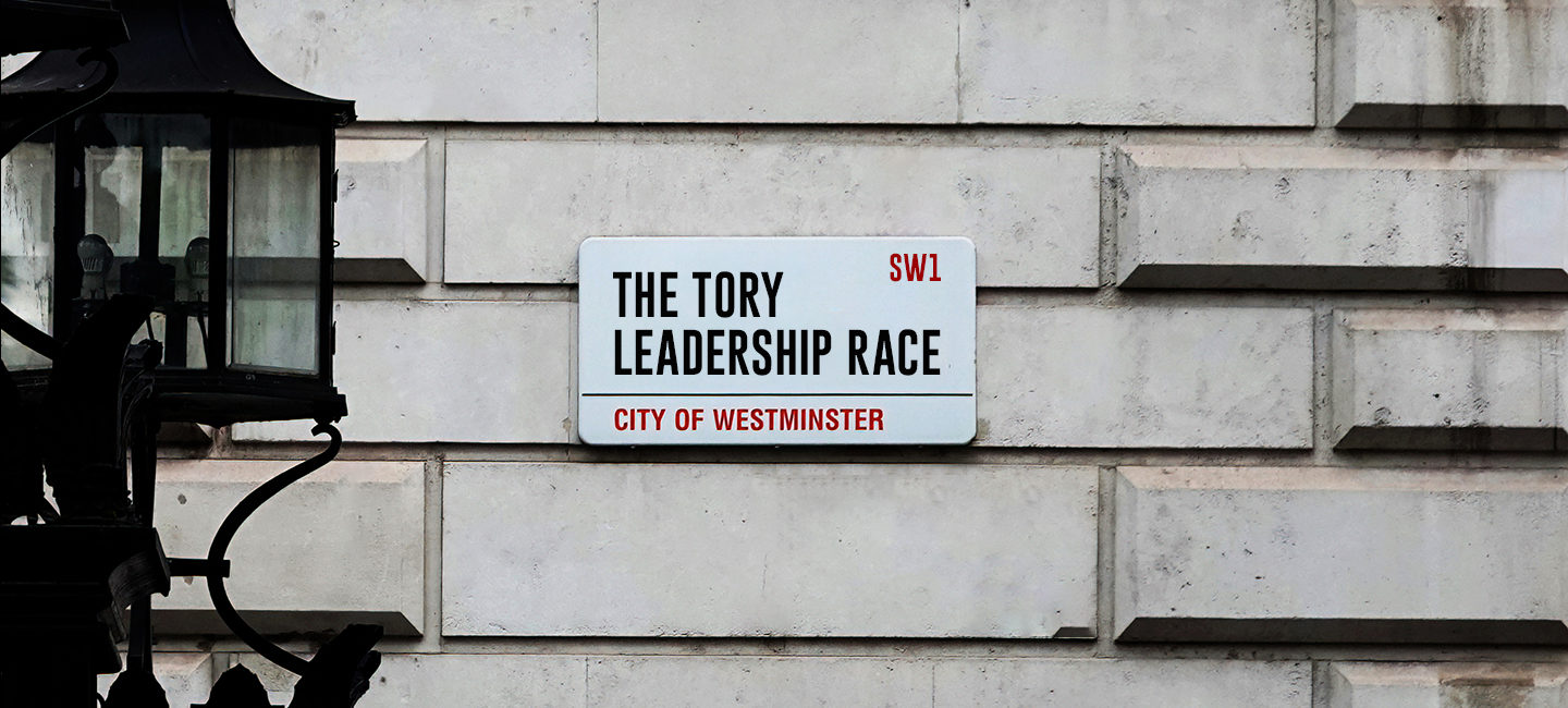 A street sign plaque on a wall which reads 'The Tory Leadership Race'