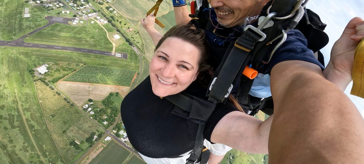 Jade smiling to camera as she skydives in Australia