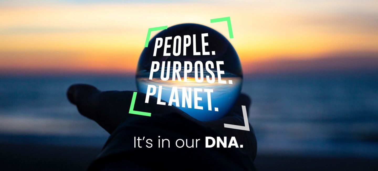 A hand holding a crystal ball with the sea and a sunset in the background and WPR's People Purpose Planet logo superimposed on the crystal ball.