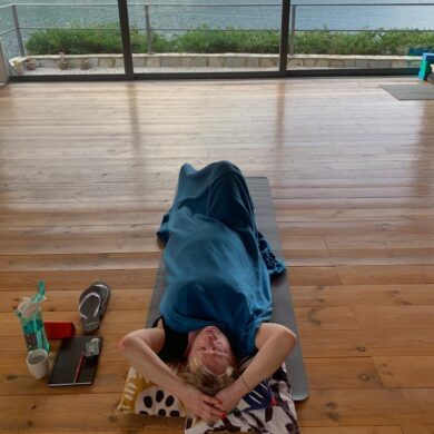 Jayne lying on the studio floor meditating