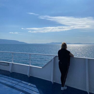 Jayne looking out to sea from the side of a boat. 