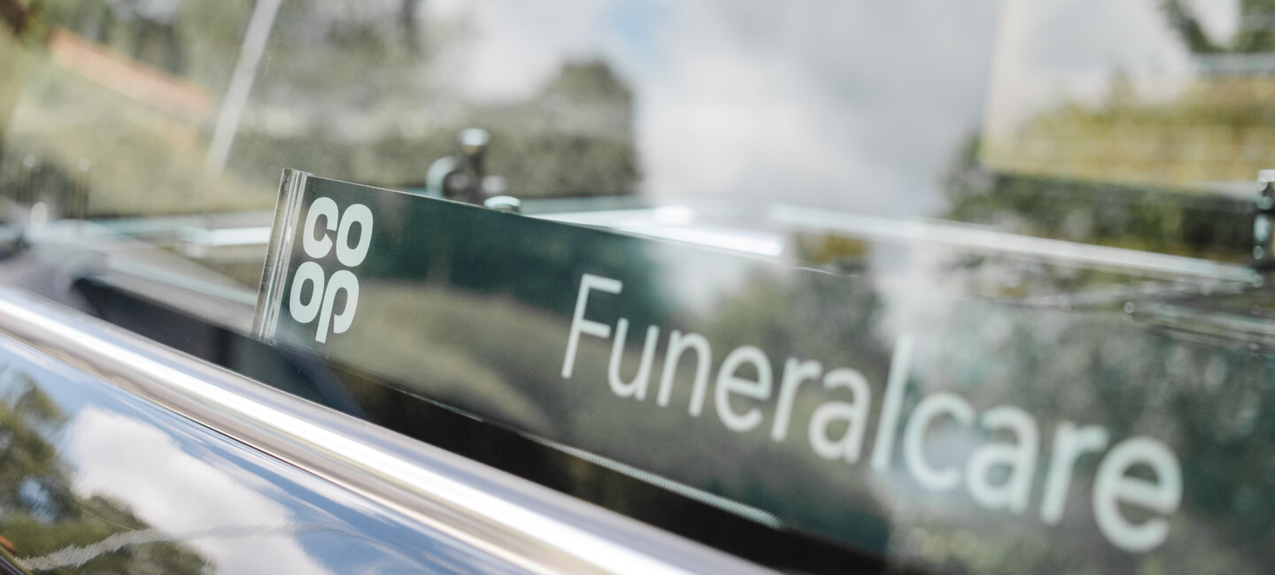 Close up of Coop Funeralcare logo in a hearse
