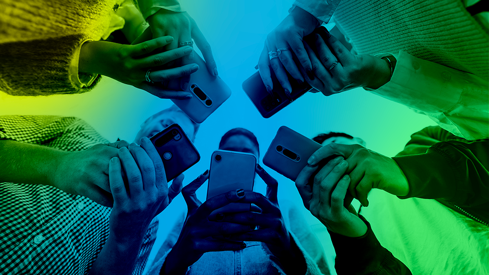 A group of people in a circle holding mobile phones