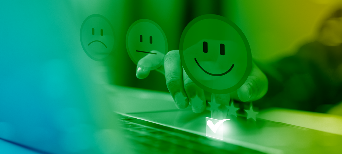 Emoji smiley face characters dancing on a laptop keyboard