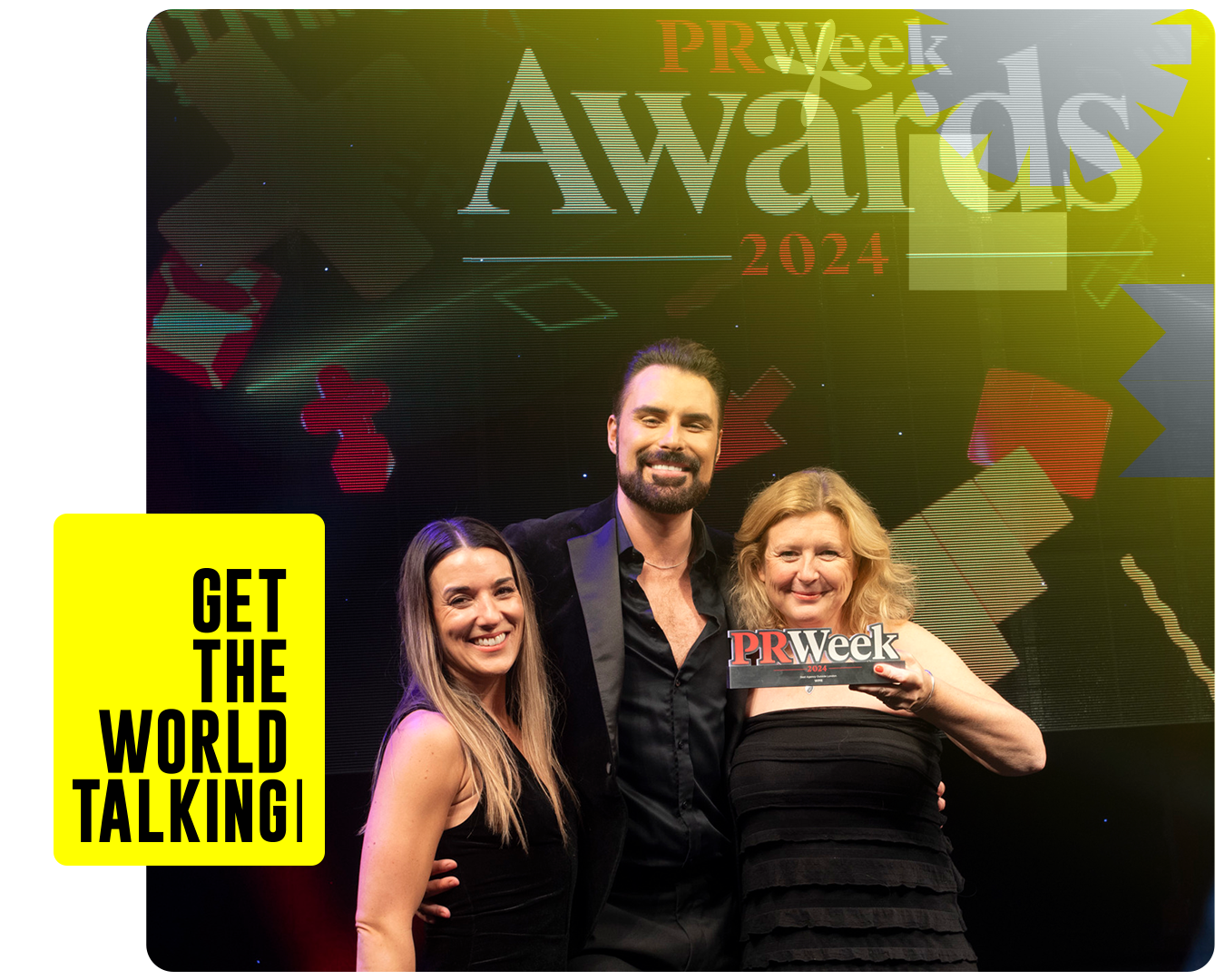 Bex and Jane being presented with an award for best agency outside London by Rylan