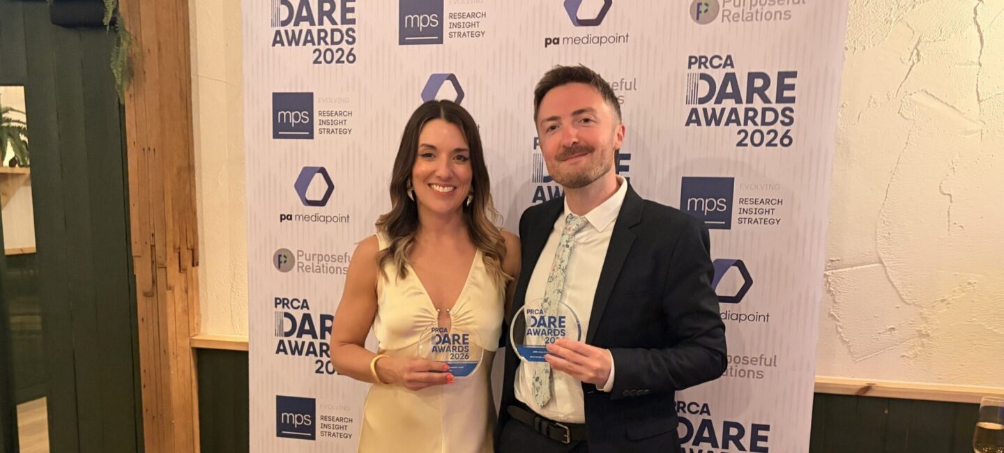 Bex and Sam smiling and holding awards