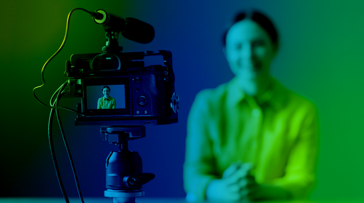 A women sitting in front of a camera being filmed